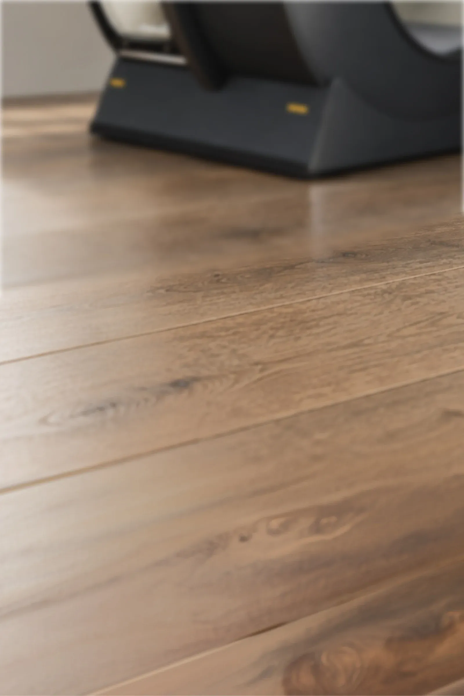 A close-up of a chamber's base resting on a hardwood floor