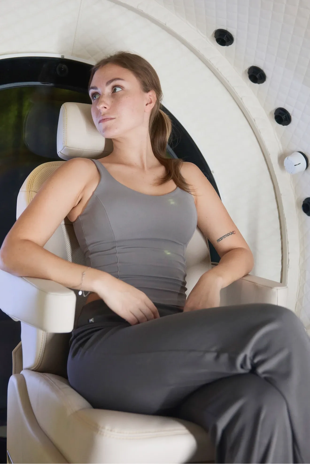 Reclined in the chamber seat, looking out through the window