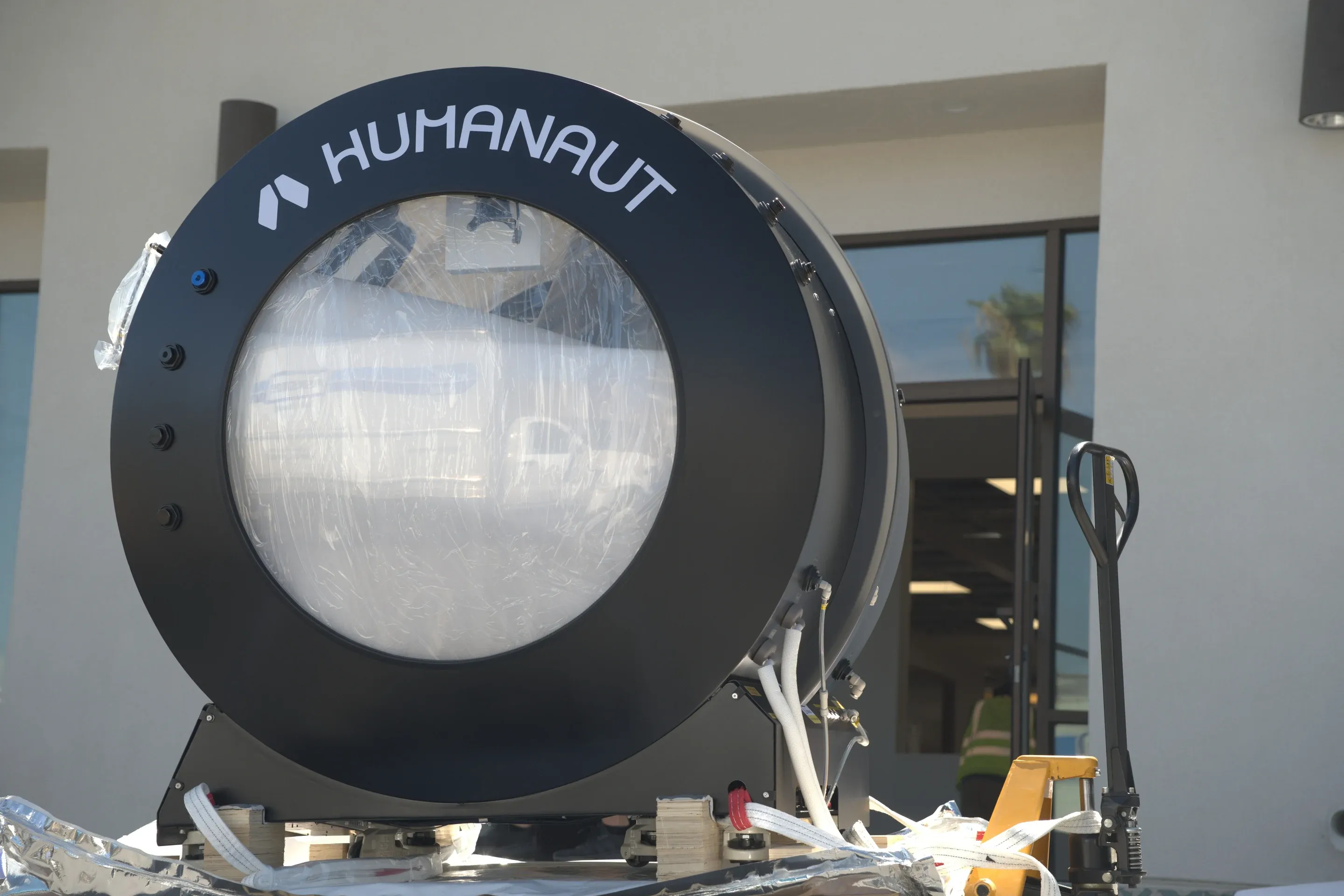 Superhuman chamber in protective film on a pallet, unloaded outside a client's building