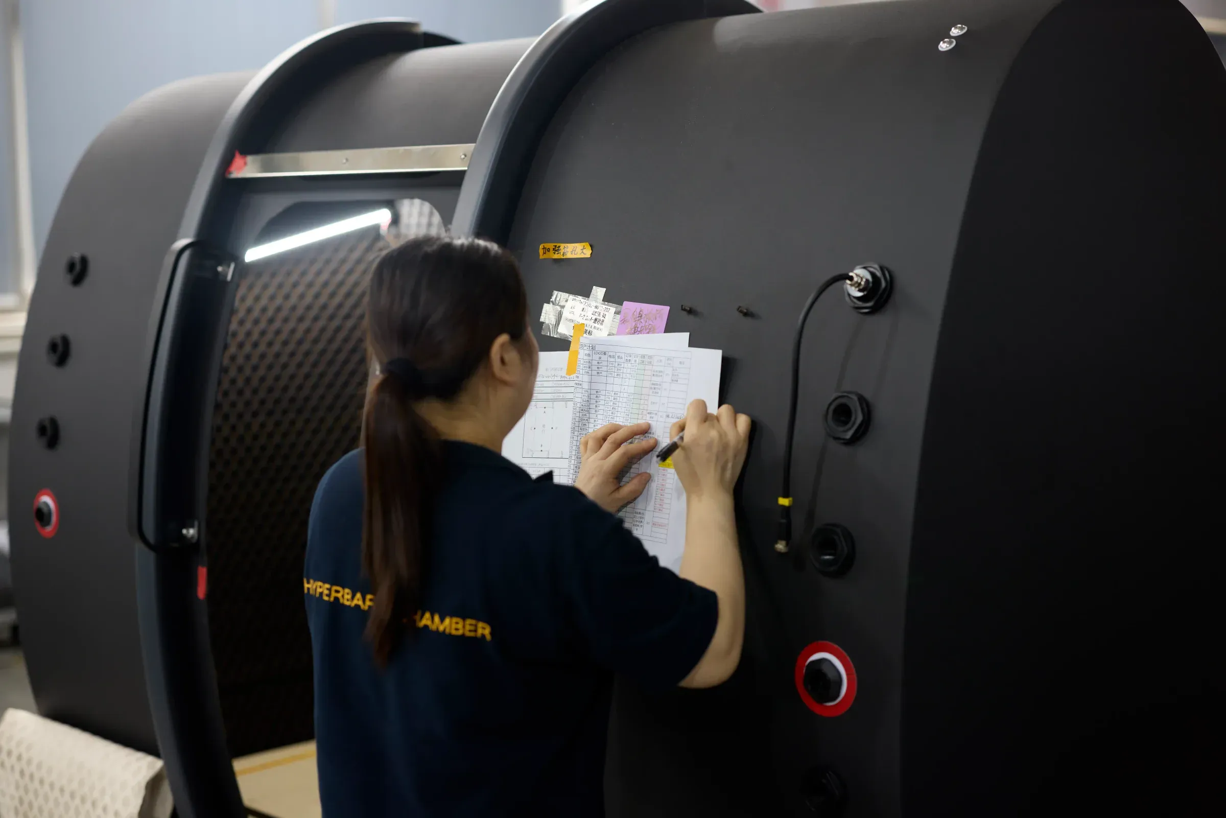 Quality inspector completing the build record sheet on a Superhuman hard-shell pressure vessel