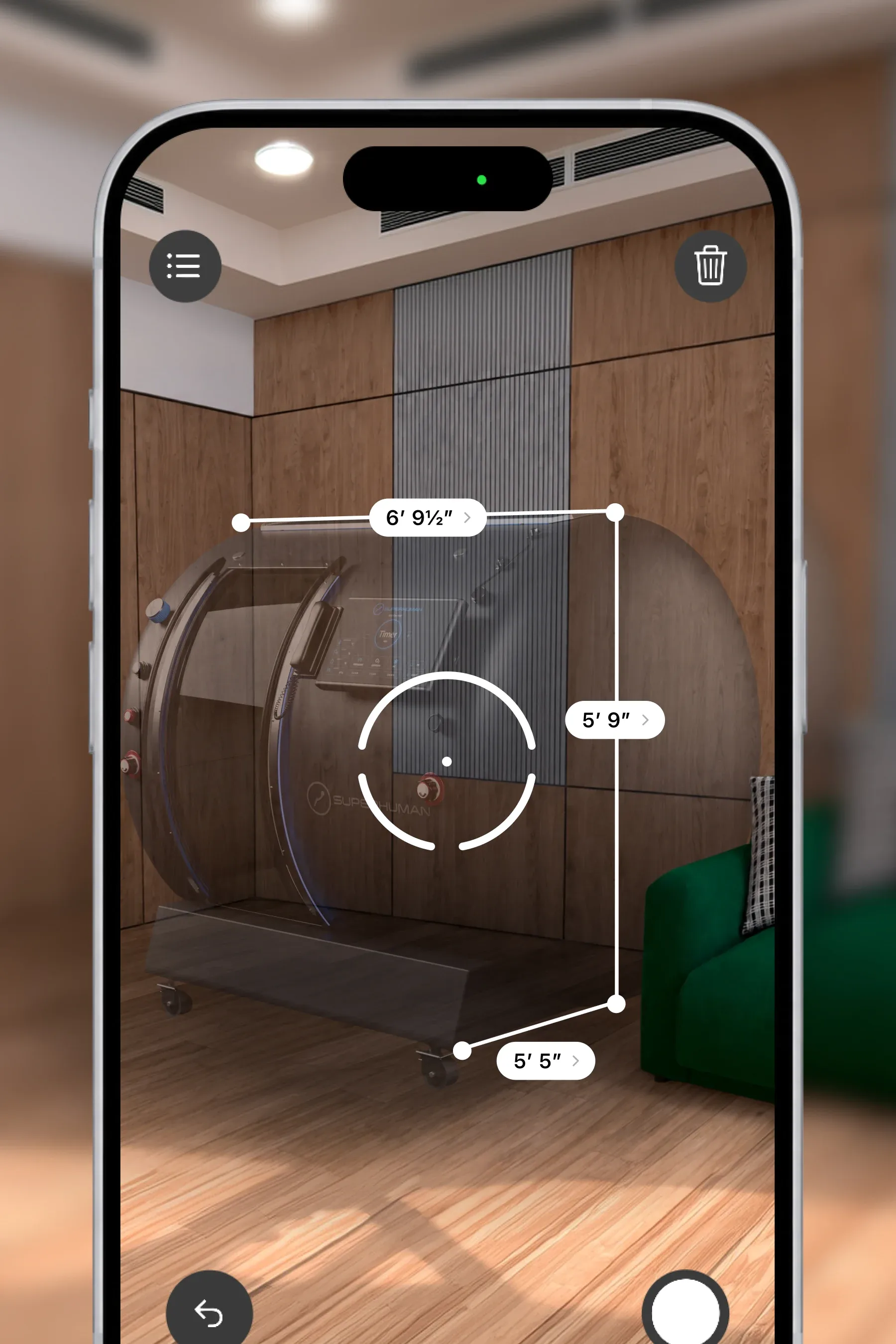 A phone measuring the T2 in a room in augmented reality, its length, width and height marked