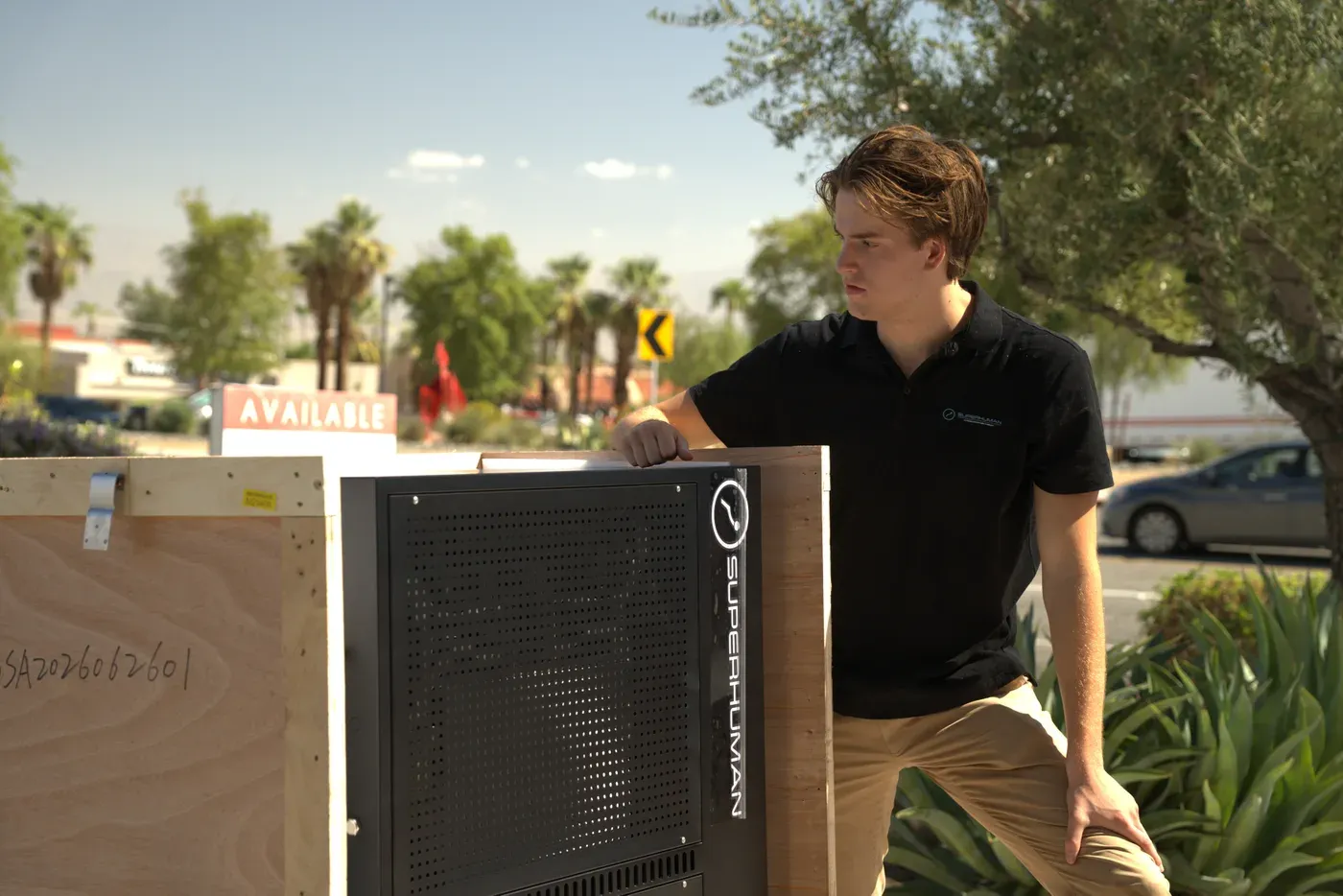 A Superhuman technician beside a chamber control panel, just uncrated outdoors in Palm Desert