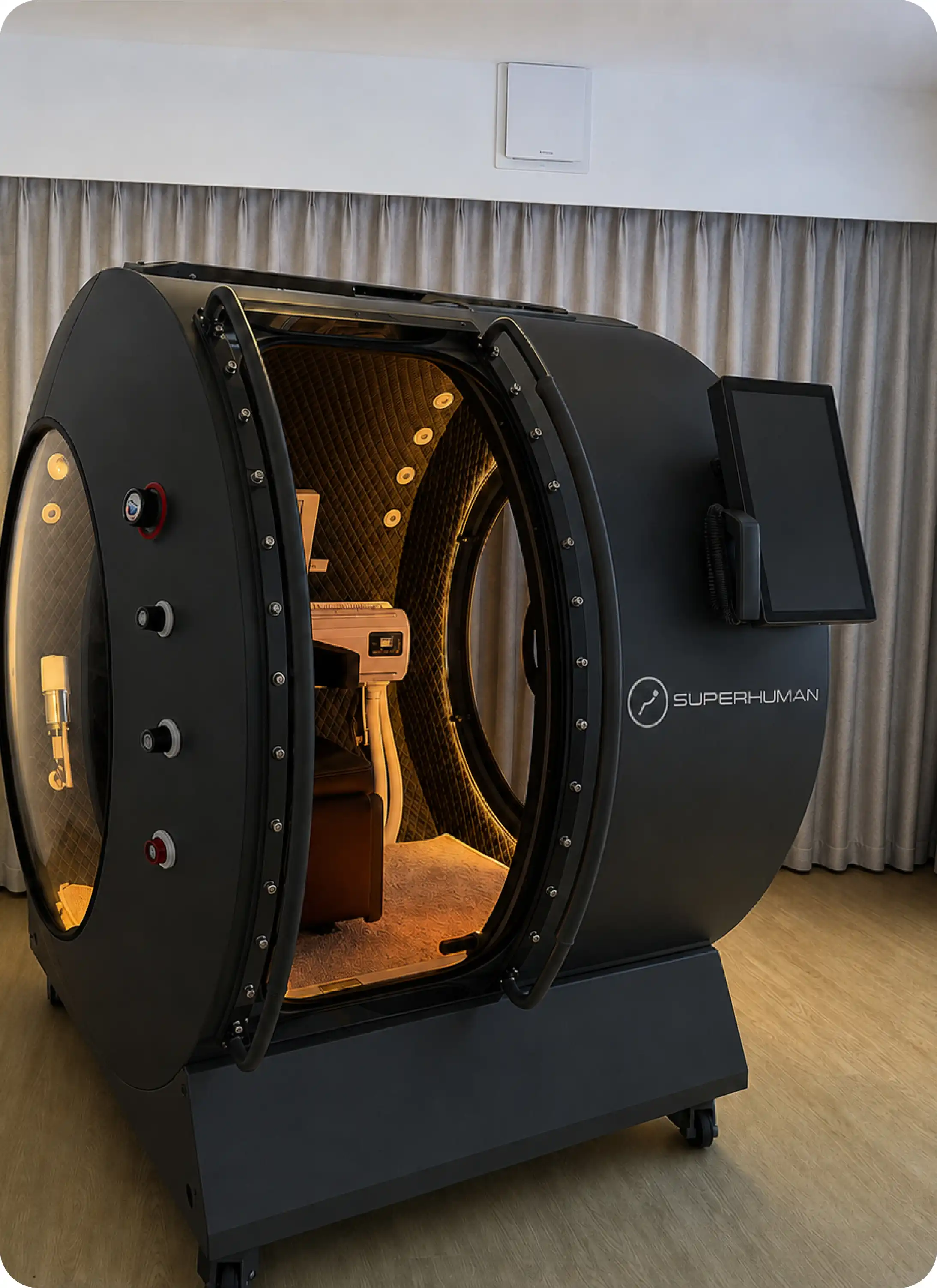 Superhuman X single-seat hard-shell hyperbaric chamber, exterior view in a wellness room